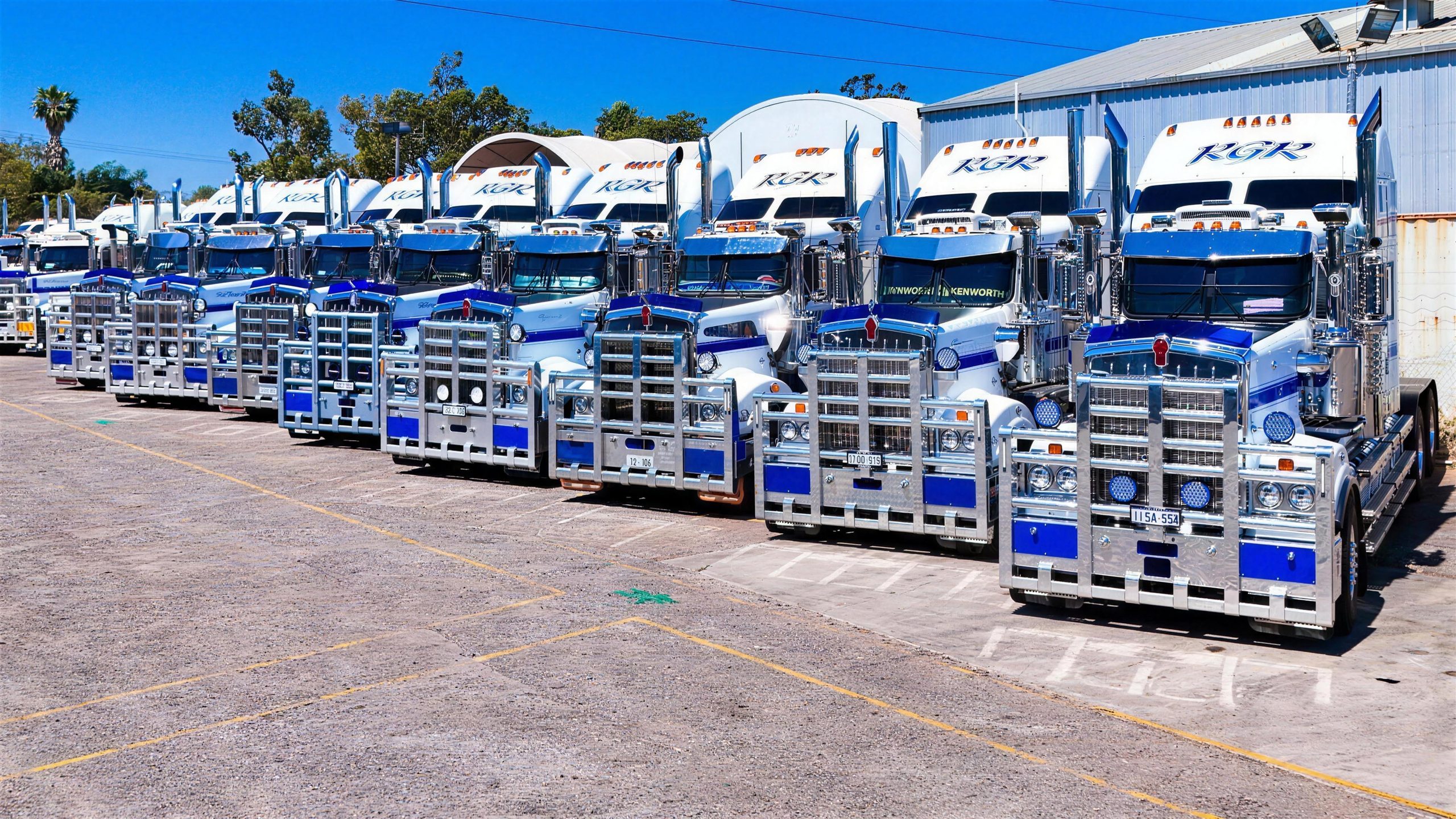 The RGR fleet of white and blue Kenworth prime movers lined up at the Midvale depot